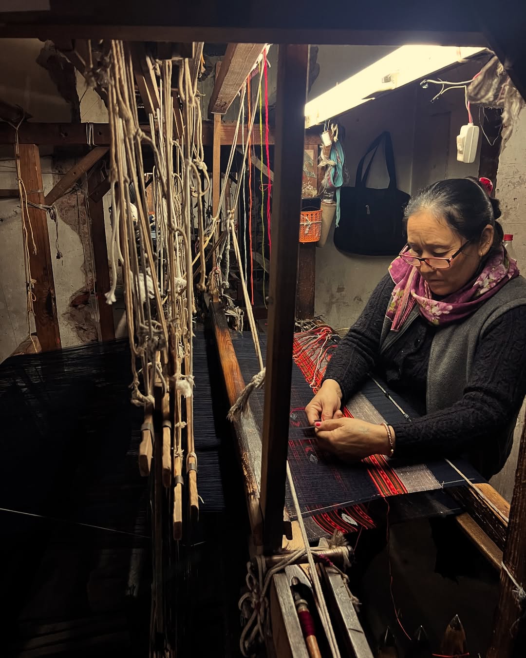 A weaver at her loom in the Kullu valley